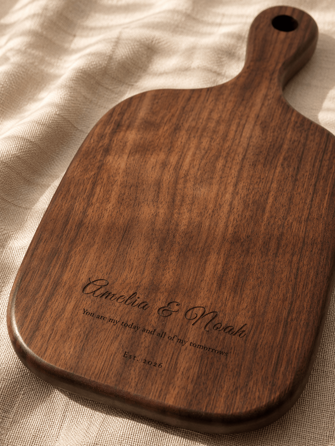 Medium walnut cutting board engraved with names and date