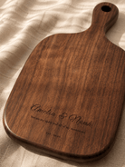 Medium walnut cutting board engraved with names and date